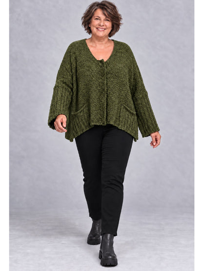 Khakifarbene Kurzstrickjacke getragen mit schwarzer Hose und Stiefeletten