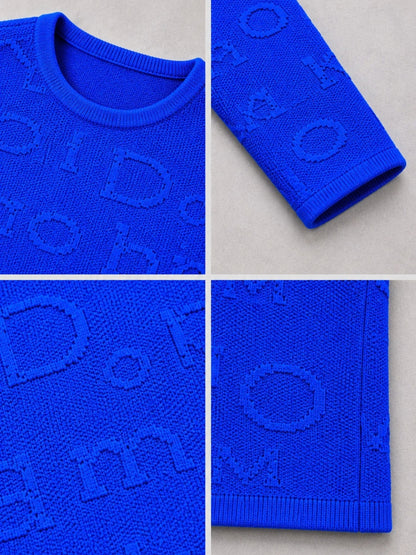 Buchstaben-Relief im Strick des royalblauen Pullovers, Detailansicht